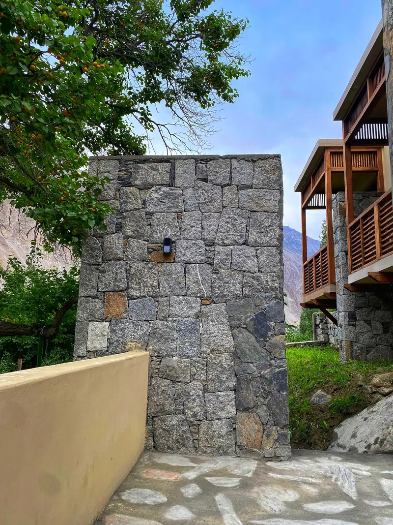 A granite pillar beside timber balconies