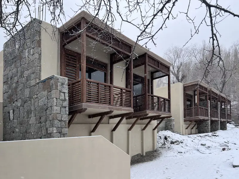 Fresh snow on the lawns and timber balconies of Diwan e Hunza